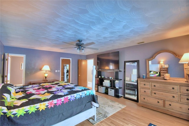 bedroom featuring light hardwood / wood-style floors and ceiling fan