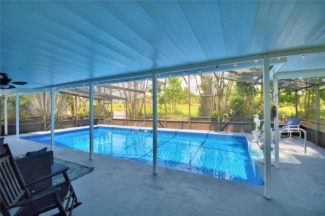 view of swimming pool with a lanai and a patio area