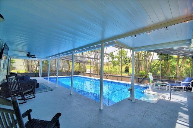 view of swimming pool featuring a lanai, an outdoor living space, ceiling fan, and a patio area