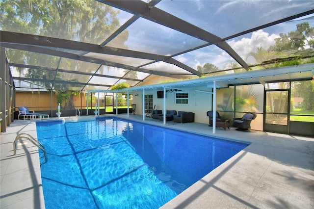 view of swimming pool featuring a patio, a lanai, and an outdoor hangout area