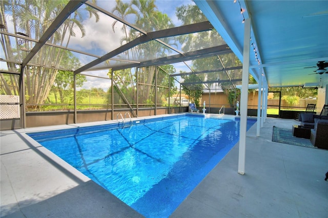 view of swimming pool with glass enclosure, ceiling fan, and a patio