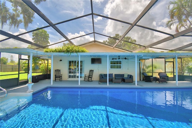 view of pool featuring a patio, a lanai, ceiling fan, and an outdoor hangout area