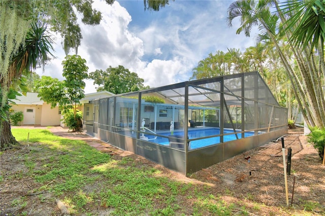 view of swimming pool featuring glass enclosure