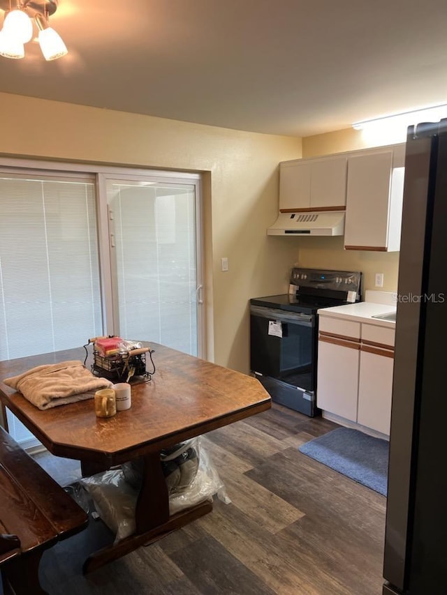 kitchen with dark hardwood / wood-style floors, fridge, and black / electric stove