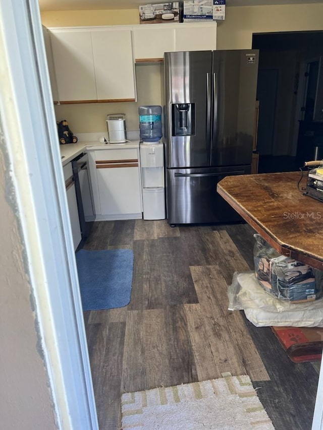 kitchen with dark hardwood / wood-style flooring, white cabinetry, and stainless steel appliances