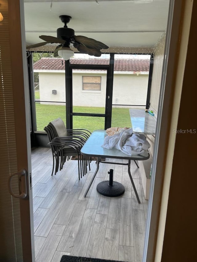 sunroom / solarium with ceiling fan and plenty of natural light