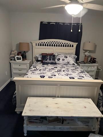 carpeted bedroom featuring ceiling fan