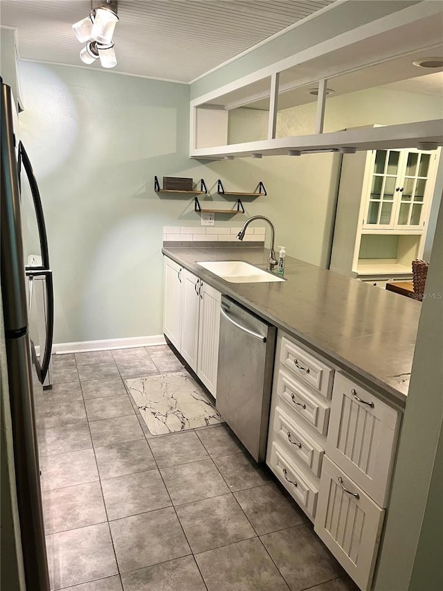 kitchen featuring tile patterned floors, white cabinetry, sink, and stainless steel appliances