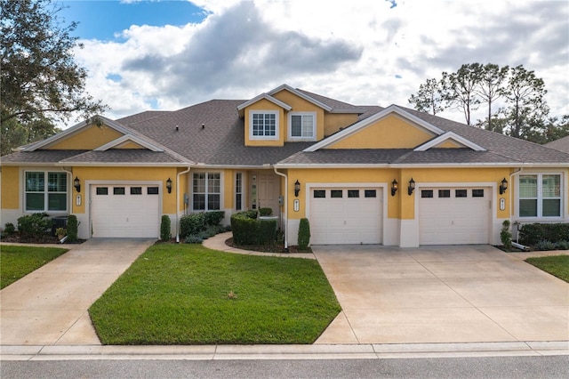 view of front of house with a garage and a front lawn