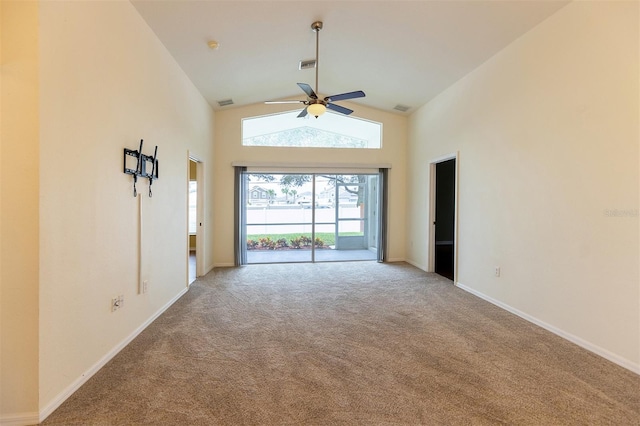 carpeted empty room with high vaulted ceiling and ceiling fan