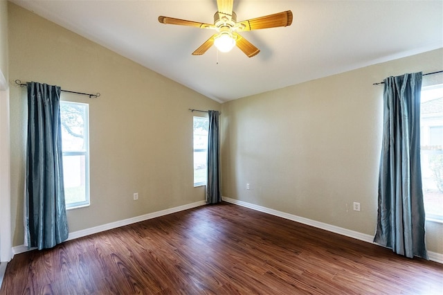 spare room with dark hardwood / wood-style flooring, lofted ceiling, ceiling fan, and plenty of natural light