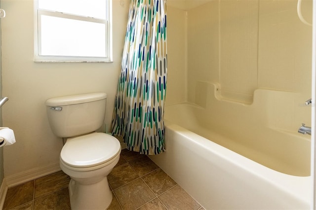 bathroom featuring shower / bath combo, tile patterned floors, and toilet