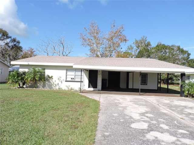 ranch-style house featuring a front lawn and a carport