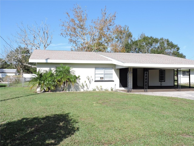 ranch-style house with a front yard and a carport