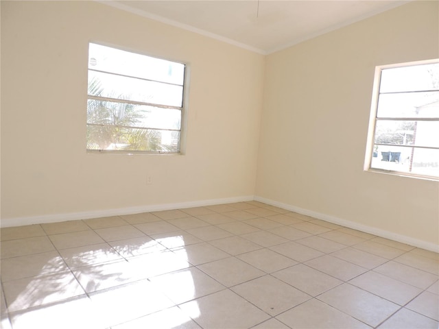 unfurnished room featuring ornamental molding and light tile patterned floors