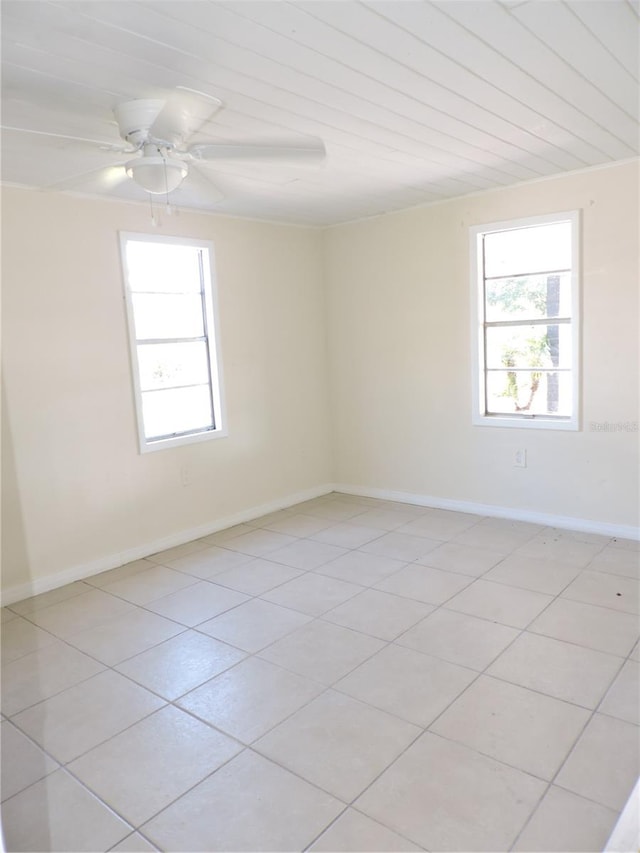 tiled empty room with wooden ceiling and ceiling fan