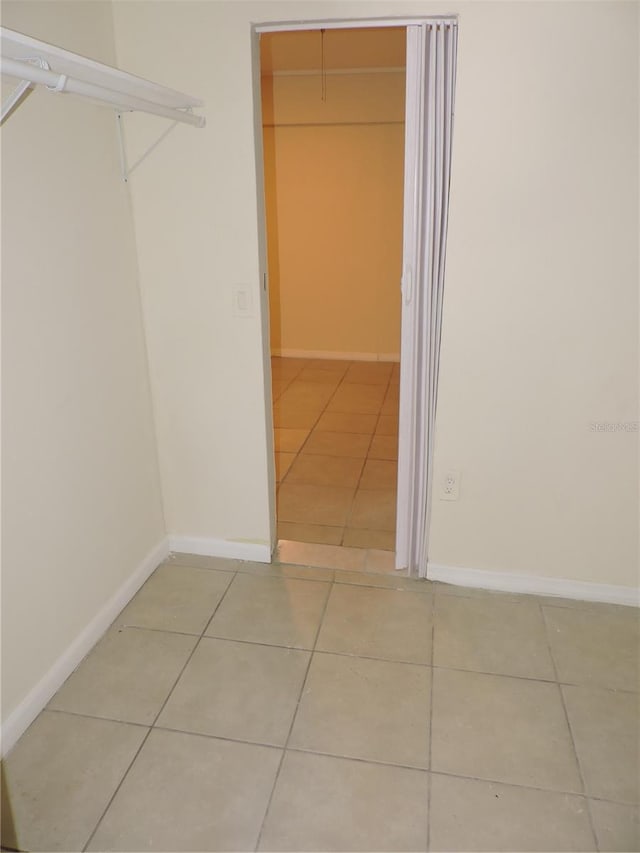 spacious closet featuring tile patterned flooring