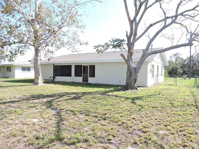 back of house with a lawn