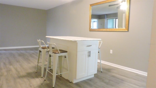 711 Springer Dr Unit 2, Lake Wales, FL 33853 - bar area featuring light wood-style floors, baseboards, and a ceiling fan