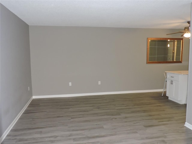 711 Springer Dr Unit 2, Lake Wales, FL 33853 - empty room featuring a ceiling fan, light wood-type flooring, and baseboards