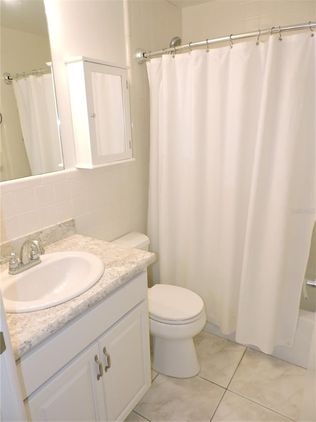 711 Springer Dr Unit 2, Lake Wales, FL 33853 - bathroom featuring vanity, toilet, tasteful backsplash, and tile patterned floors