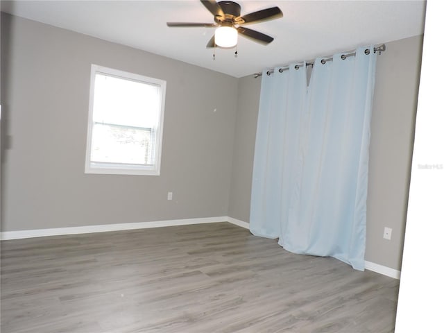 711 Springer Dr Unit 2, Lake Wales, FL 33853 - spare room with light wood finished floors, a ceiling fan, and baseboards