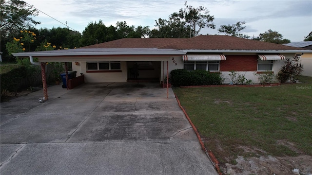 ranch-style home with a front yard and a carport