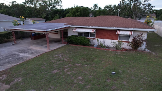 single story home featuring a carport and a front yard