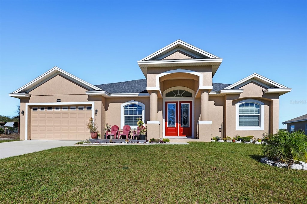 view of front facade with a front yard and a garage