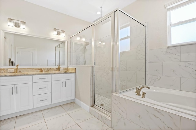 bathroom with vanity and shower with separate bathtub