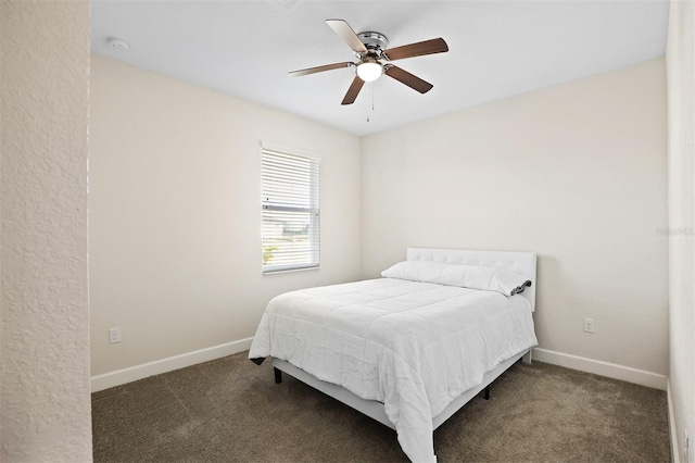 bedroom with dark colored carpet and ceiling fan