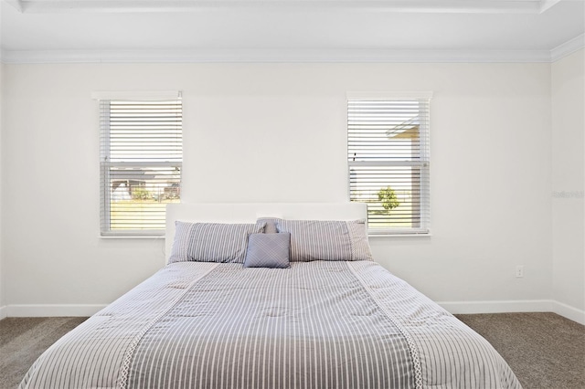 carpeted bedroom featuring multiple windows and ornamental molding