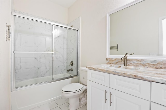 full bathroom featuring vanity, toilet, and bath / shower combo with glass door