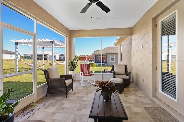 sunroom / solarium featuring ceiling fan and a healthy amount of sunlight