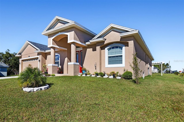 view of front of property with a front yard and a garage