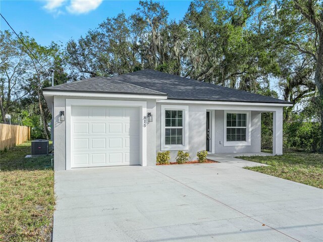 815 S Seminole Ave, Fort Meade, FL 33841 - view of front of house featuring concrete driveway, stucco siding, a garage, and roof with shingles