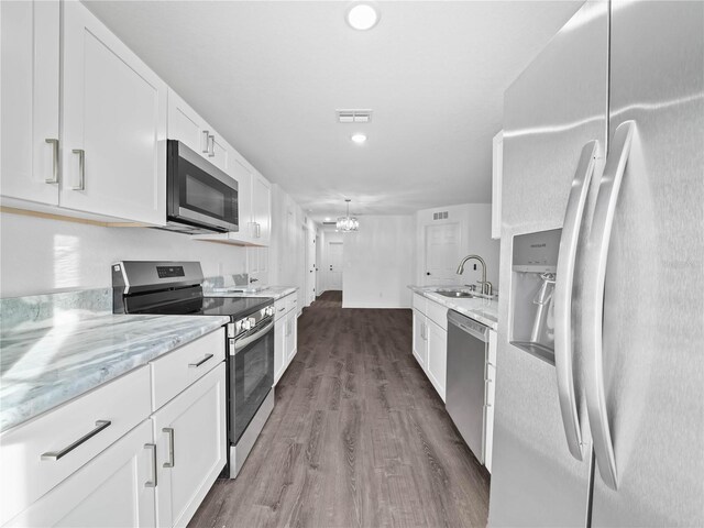 815 S Seminole Ave, Fort Meade, FL 33841 - kitchen featuring stainless steel appliances, dark wood finished floors, white cabinets, light stone counters, and recessed lighting