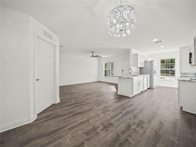 kitchen with dark hardwood / wood-style floors, a healthy amount of sunlight, white cabinetry, and sink