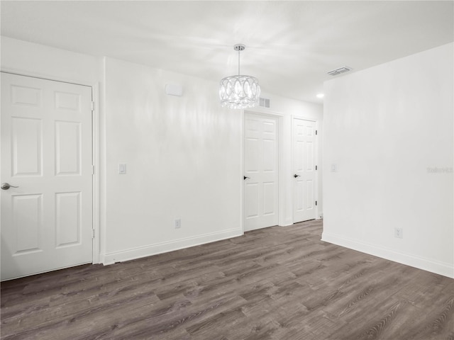 815 S Seminole Ave, Fort Meade, FL 33841 - empty room with dark wood finished floors and a chandelier