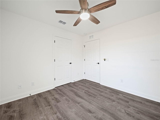 unfurnished room with ceiling fan and dark hardwood / wood-style flooring