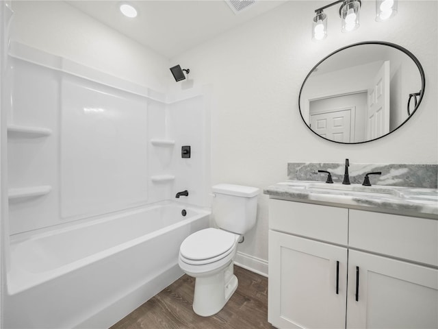 full bathroom featuring hardwood / wood-style floors, vanity, shower / bathtub combination, and toilet