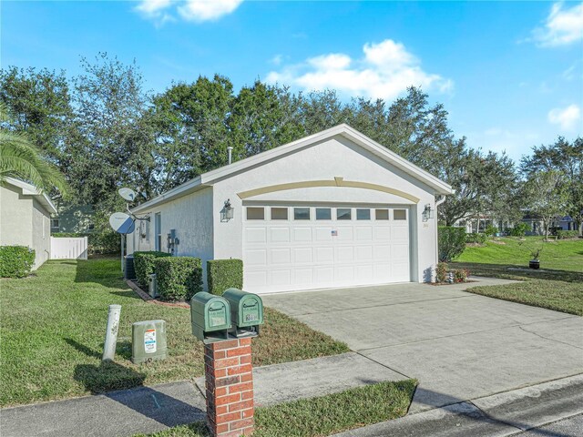 341 Lake Suzanne Dr, Lake Wales, FL 33859 - view of front of property with a front lawn, concrete driveway, stucco siding, and an attached garage