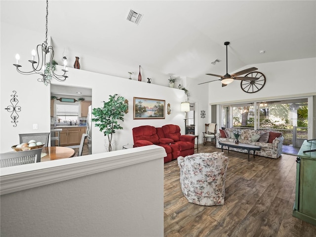 living room with plenty of natural light, dark hardwood / wood-style floors, sink, and high vaulted ceiling