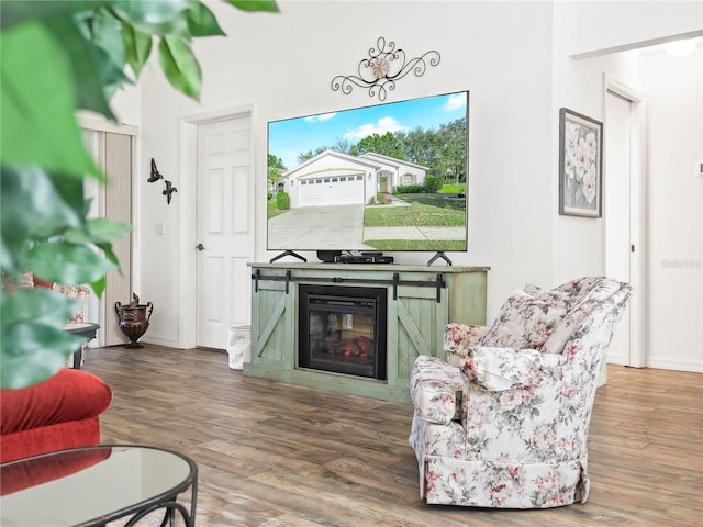341 Lake Suzanne Dr, Lake Wales, FL 33859 - living room featuring wood finished floors and a glass covered fireplace