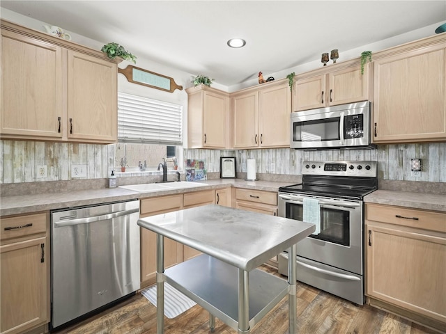 kitchen with sink, stainless steel appliances, dark hardwood / wood-style floors, decorative backsplash, and light brown cabinetry