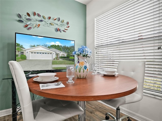 dining area featuring plenty of natural light and wood-type flooring