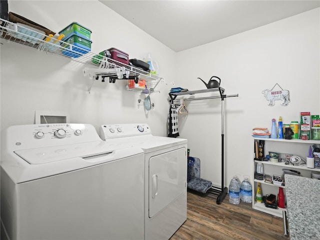 laundry area with dark hardwood / wood-style floors and washing machine and dryer