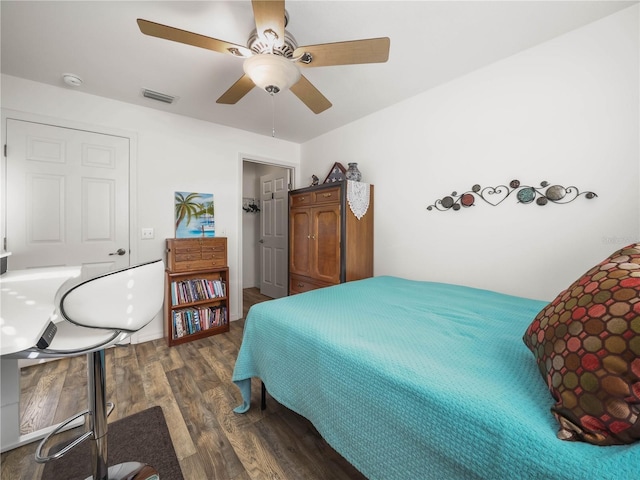 bedroom with dark hardwood / wood-style floors and ceiling fan