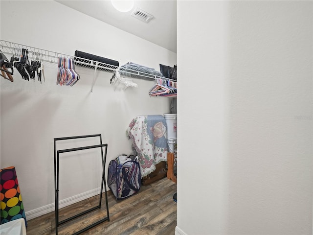 spacious closet featuring dark hardwood / wood-style floors