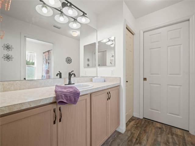 bathroom featuring hardwood / wood-style floors and vanity